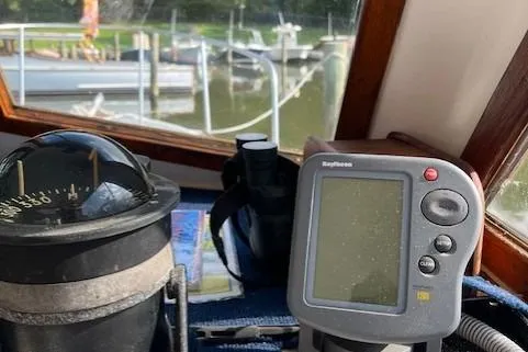 Slide: The Image of Compass and navigation equipment inside a 1985 Albin 27 Family boat cockpit. - 10