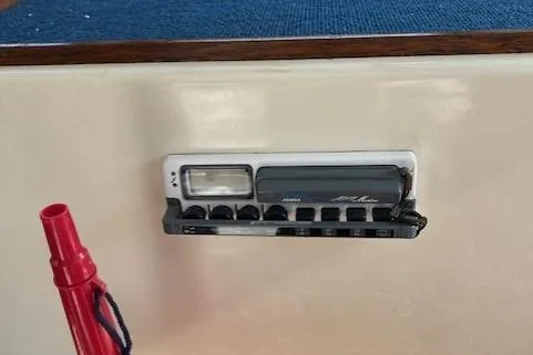 Slide: The Image of Control panel on 1985 Albin 27 Family boat interior with red safety equipment. - 11