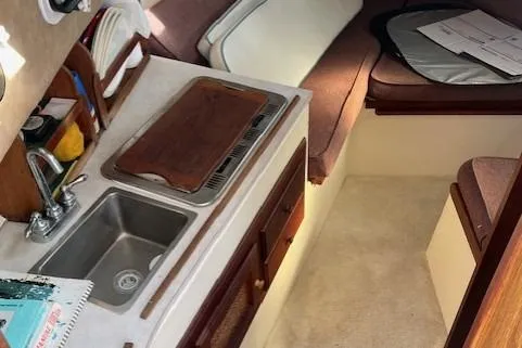 Slide: The Image of 1985 Albin 27 Family boat interior with kitchenette and seating area. - 12