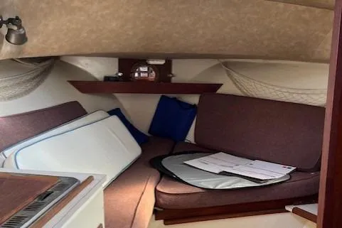 Slide: The Image of Interior of 1985 Albin 27 Family boat with cozy seating and storage. - 13
