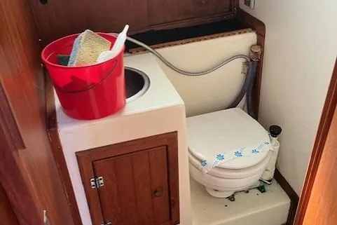 Slide: The Image of Compact bathroom in 1985 Albin 27 Family boat with toilet and cleaning supplies. - 14