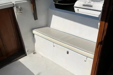 Slide: The Image of 1985 Albin 27 Family boat interior with white cushioned seating. - 16
