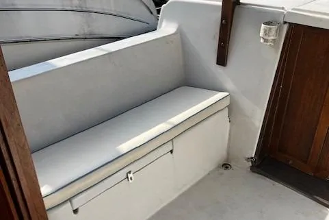 Slide: The Image of 1985 Albin 27 Family boat interior with white seating and wooden accents. - 17