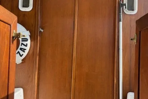 Slide: The Image of 1985 Albin 27 Family boat interior with wooden paneling and life preserver. - 7