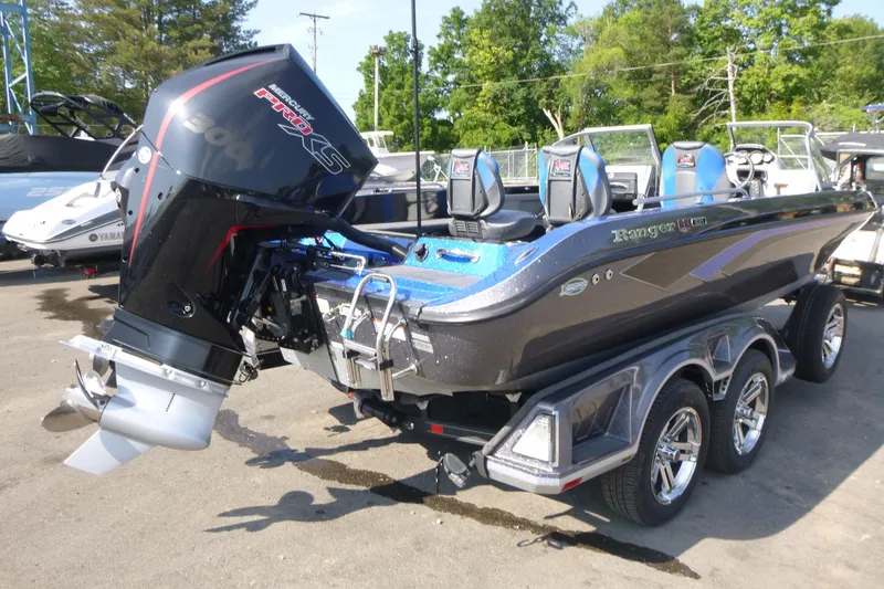 Slide: The Image of 2024 Ranger 621FS Ranger Cup Equipped boat with powerful Mercury engine, parked outdoors. - 2