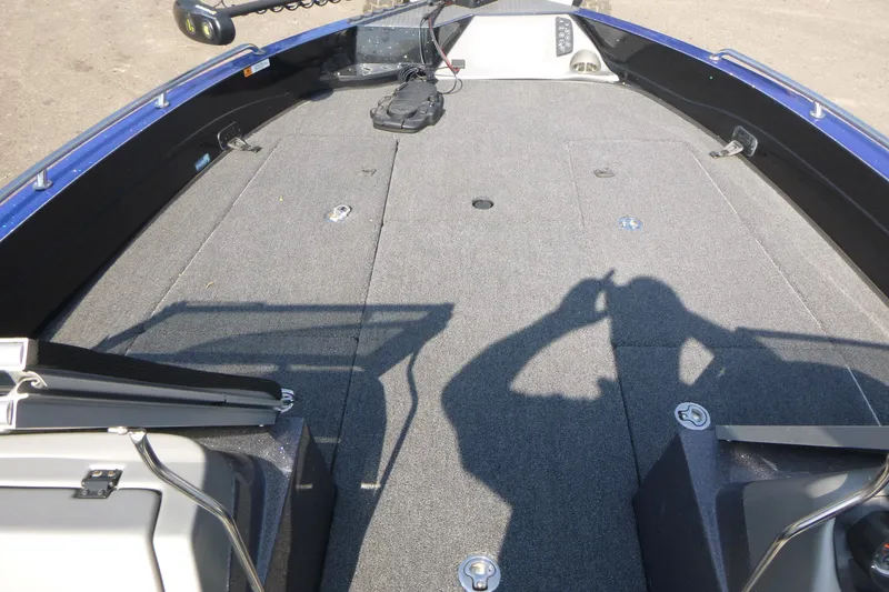 Slide: The Image of 2024 Ranger 621FS Ranger Cup Equipped boat deck with carpeted surface and storage compartments. - 9