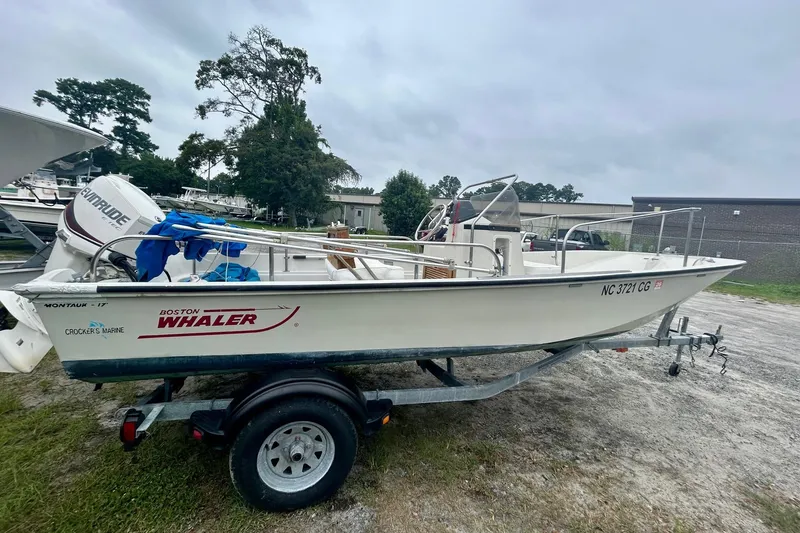 Slide: The Image of 1993 Boston Whaler 17 Montauk boat on trailer, parked outdoors. - 2