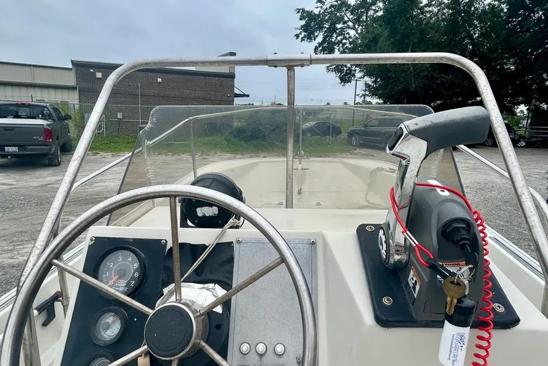 Slide: The Image of 1993 Boston Whaler 17 Montauk boat dashboard with steering wheel and throttle controls. - 5