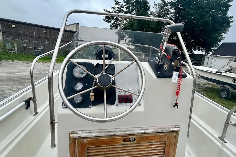 Slide: The Image of 1993 Boston Whaler 17 Montauk boat dashboard with steering wheel and controls. - 7