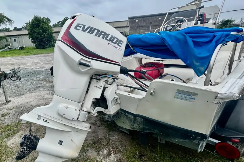 Slide: The Image of 1993 Boston Whaler 17 Montauk with Evinrude outboard motor, parked outdoors. - 8