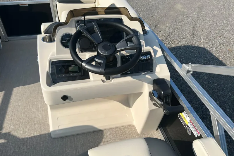 Slide: The Image of 2026 Tahoe Pontoon 1780 CRB steering console with controls and gauges. - 11