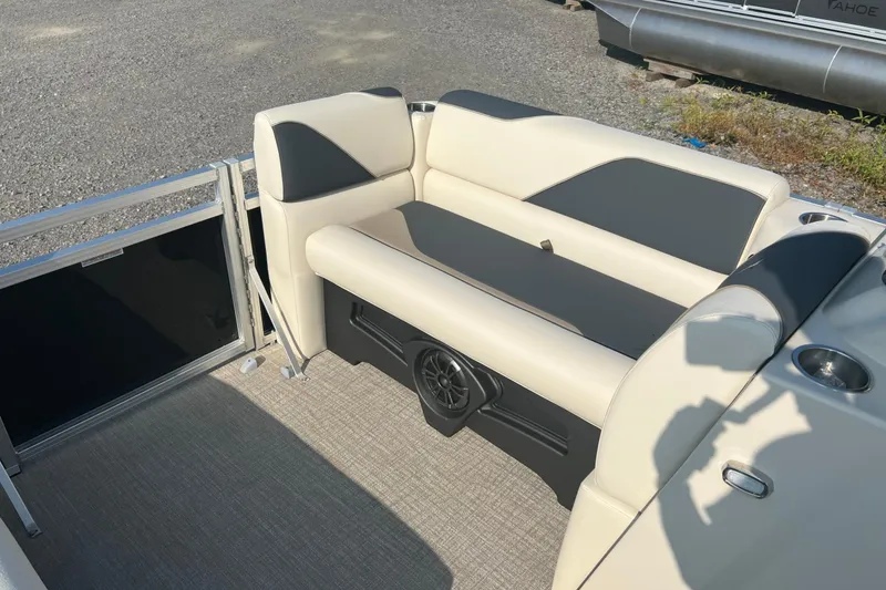 Slide: The Image of 2026 Tahoe Pontoon 1780 CRB interior with beige and gray seating, speaker, and cup holder. - 13