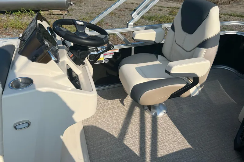 Slide: The Image of 2026 Tahoe Pontoon 1780 CRB helm with steering wheel and captain's chair. - 14