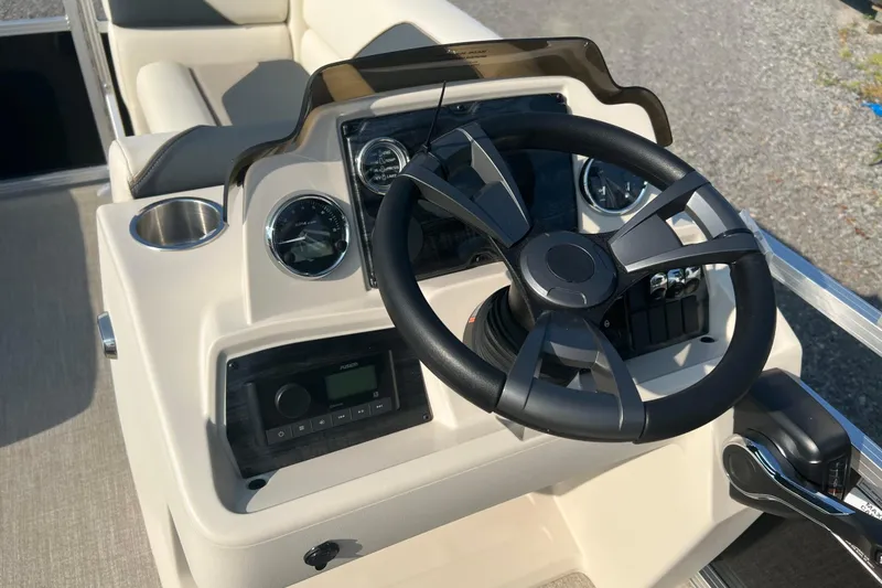 Slide: The Image of 2026 Tahoe Pontoon 1780 CRB steering console with modern controls and gauges. - 15