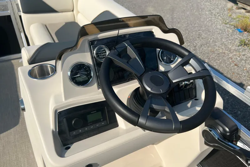 Slide: The Image of 2026 Tahoe Pontoon 1780 CRB steering console with gauges and controls. - 16