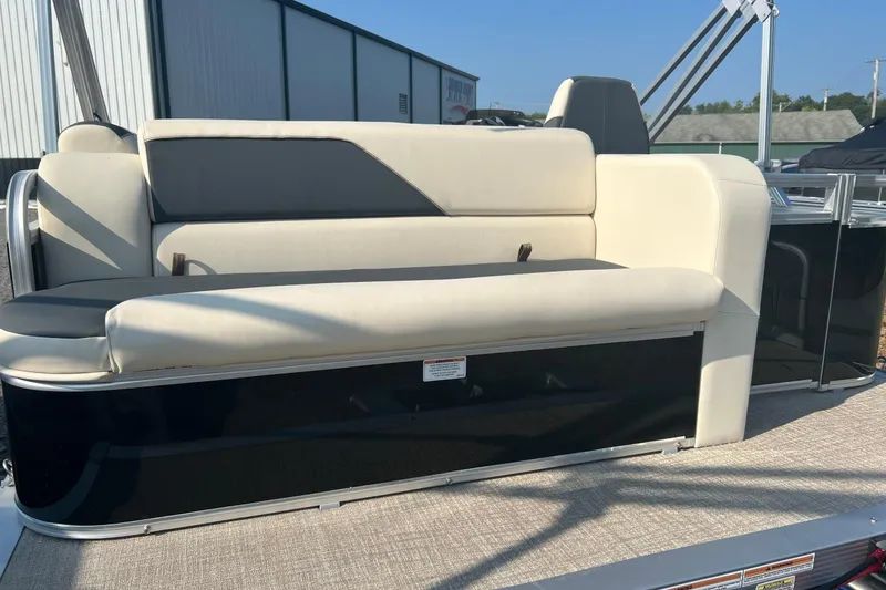 Slide: The Image of 2026 Tahoe Pontoon 1780 CRB with beige seating, displayed outdoors. - 5