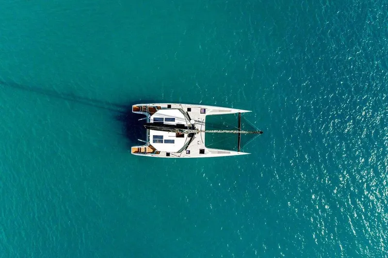Slide: The Image of Aerial view of 2018 Gunboat 57 catamaran sailing on clear turquoise water. - 13
