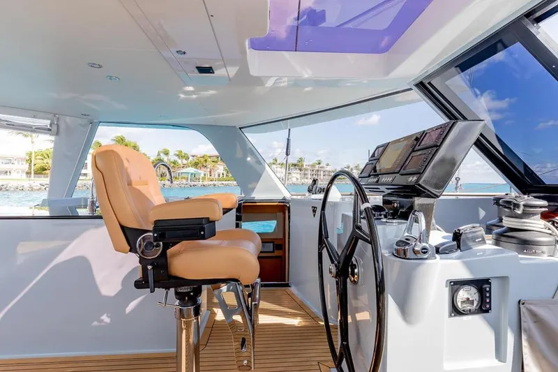 Slide: The Image of Luxurious 2018 Gunboat 57 yacht helm with leather captain's chair and advanced navigation controls. - 18