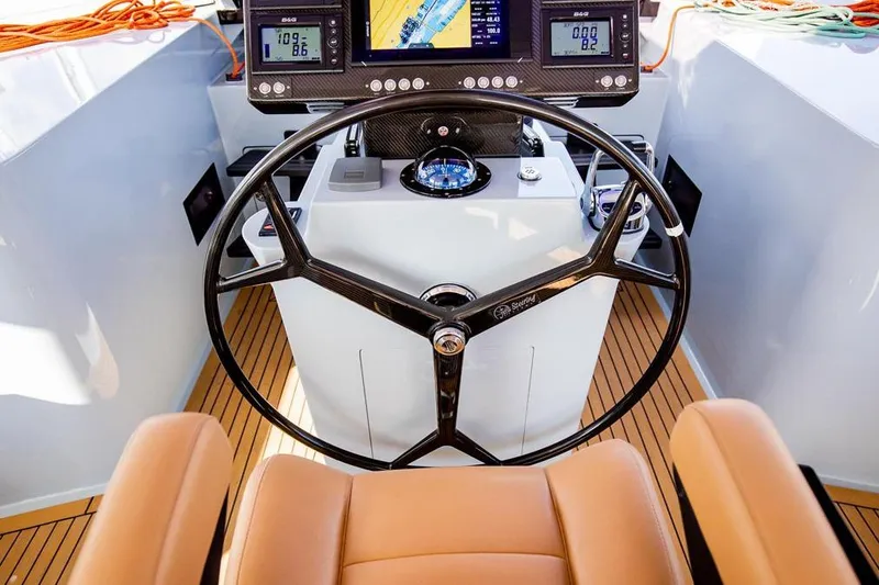 Slide: The Image of Helm of 2018 Gunboat 57 yacht with navigation instruments and leather seating. - 20