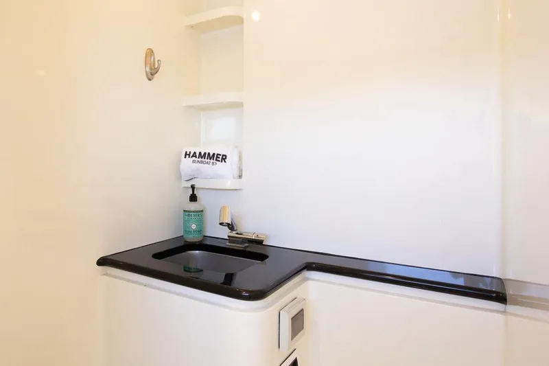 Slide: The Image of Luxury bathroom sink area on 2018 Gunboat 57 yacht, featuring sleek black countertop. - 46