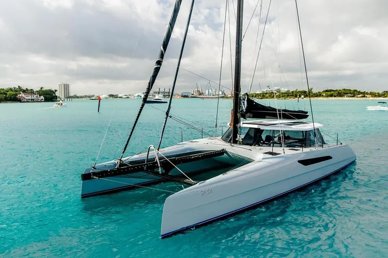 Slide: The Image of 2018 Gunboat 57 catamaran sailing on turquoise waters under cloudy skies. - 6