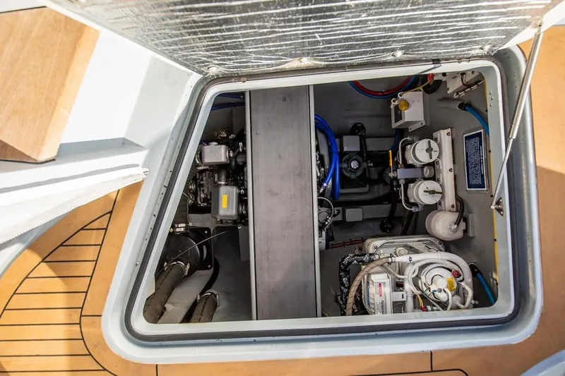 Slide: The Image of Engine compartment of a 2018 Gunboat 57, showcasing mechanical components and wiring. - 61