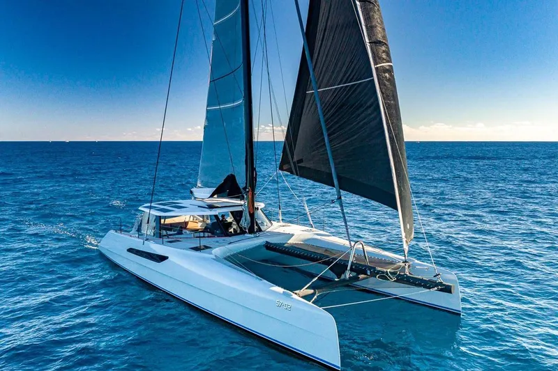Slide: The Image of 2018 Gunboat 57 catamaran sailing on clear blue ocean waters. - 66
