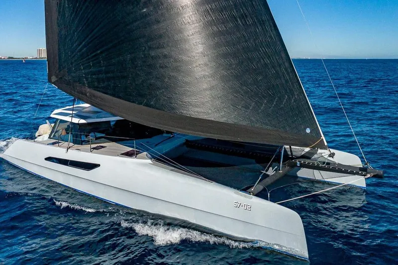 Slide: The Image of 2018 Gunboat 57 sailing catamaran gliding on blue ocean waters. - 67