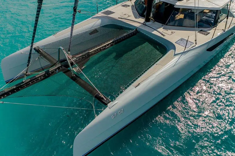 Slide: The Image of 2018 Gunboat 57 catamaran sailing on clear turquoise waters. - 8