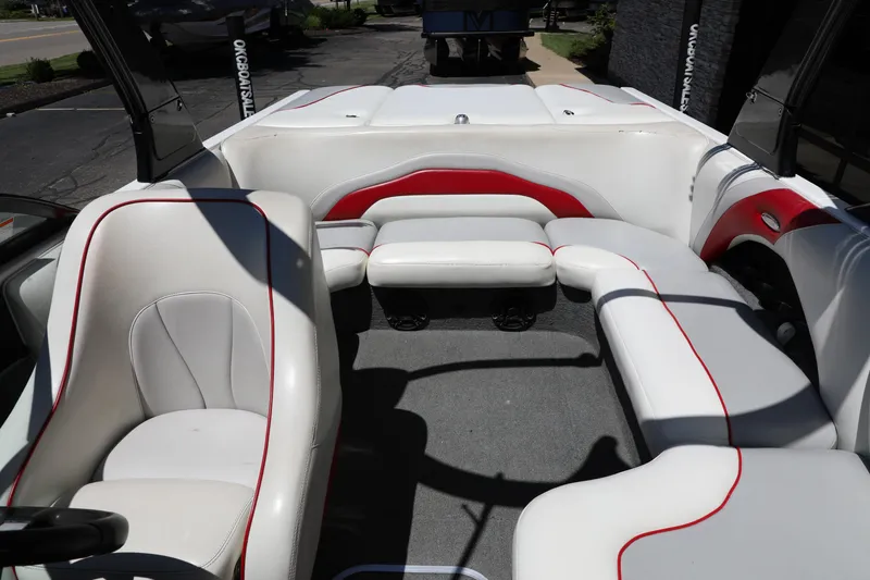 Slide: The Image of 2008 Malibu 21 vRide boat interior with white and red seating, spacious layout. - 7