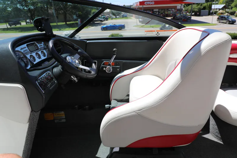 Slide: The Image of 2008 Malibu 21 vRide boat interior with steering wheel and dashboard controls. - 8