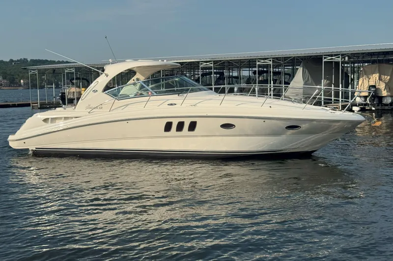 Slide: The Image of 2006 Sea Ray 380 Sundancer yacht docked on calm water, side view. - 0