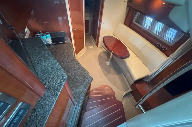 Slide: The Image of Interior of 2006 Sea Ray 380 Sundancer yacht with kitchenette and seating area. - 13