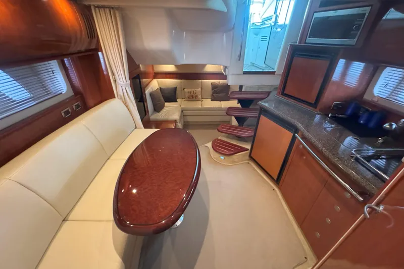 Slide: The Image of Luxurious interior of 2006 Sea Ray 380 Sundancer yacht with elegant seating and kitchen area. - 15