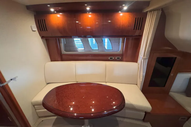 Slide: The Image of Interior of 2006 Sea Ray 380 Sundancer with elegant seating and polished wood table. - 17