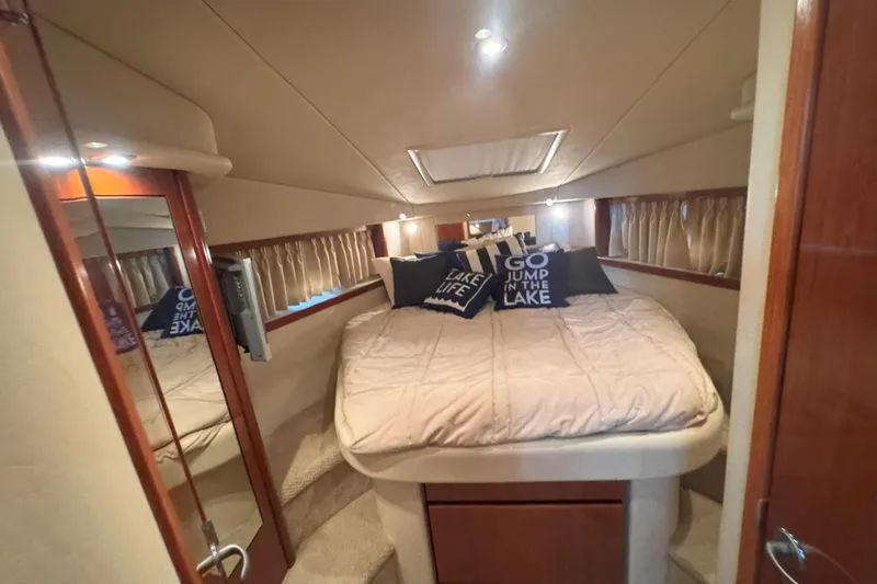 Slide: The Image of Luxurious cabin interior of 2006 Sea Ray 380 Sundancer with cozy bedding and decorative pillows. - 18