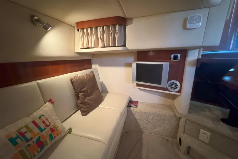 Slide: The Image of Interior of 2006 Sea Ray 380 Sundancer with cozy seating and small TV. - 19