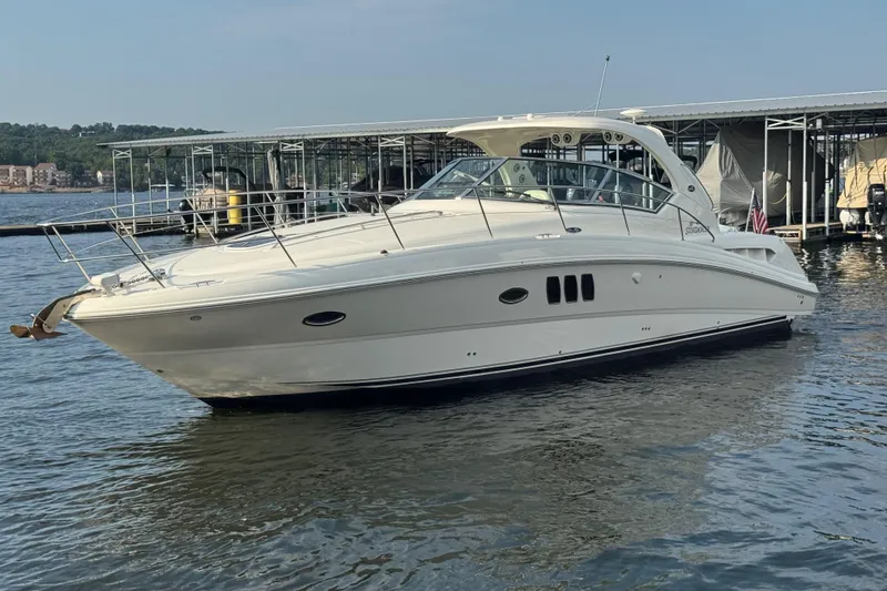 Slide: The Image of 2006 Sea Ray 380 Sundancer yacht docked on a calm lake. - 2