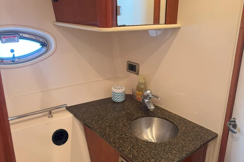 Slide: The Image of Bathroom interior of 2006 Sea Ray 380 Sundancer yacht with sink and porthole window. - 20