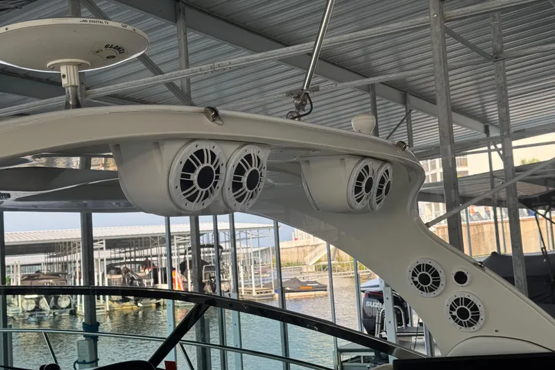 Slide: The Image of 2006 Sea Ray 380 Sundancer boat with mounted speakers in a marina. - 22