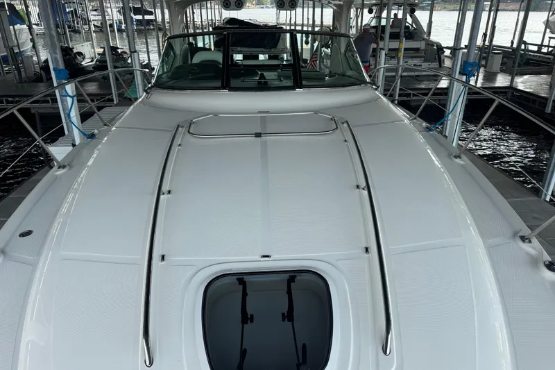 Slide: The Image of 2006 Sea Ray 380 Sundancer yacht docked, showcasing sleek deck design and modern features. - 24