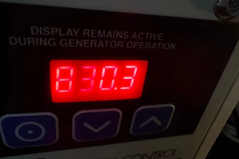Slide: The Image of Digital display showing "830.3" on a 2006 Sea Ray 380 Sundancer generator panel. - 28
