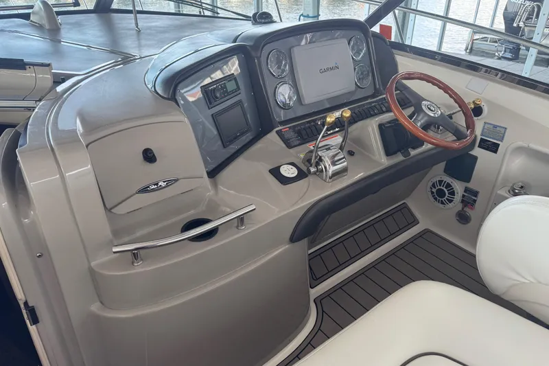 Slide: The Image of 2006 Sea Ray 380 Sundancer helm with Garmin navigation and wood steering wheel. - 6