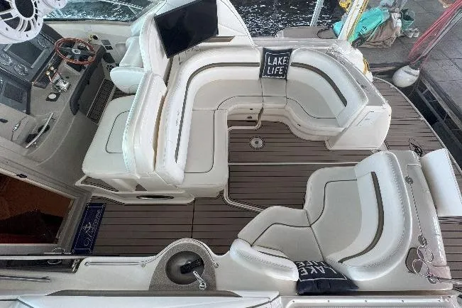 Slide: The Image of 2006 Sea Ray 380 Sundancer interior with plush seating and "Lake Life" decor. - 7