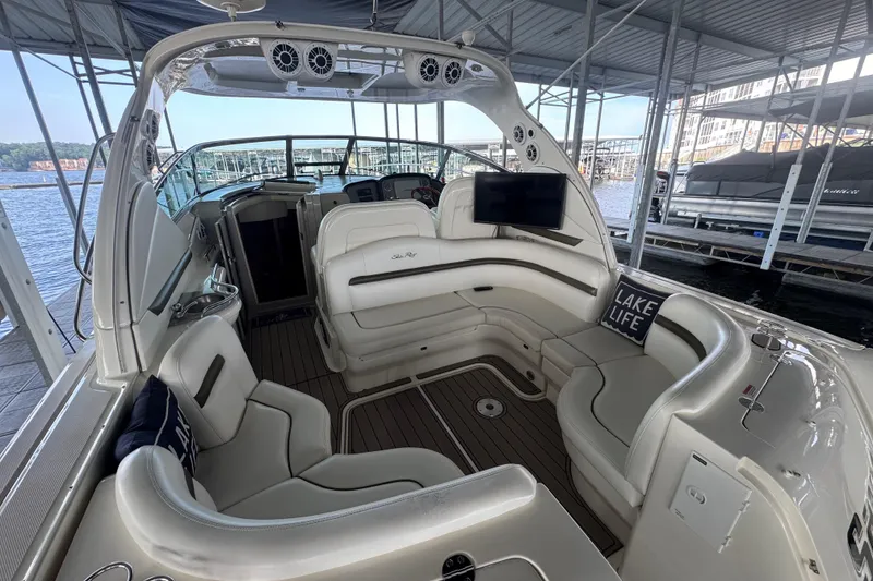 Slide: The Image of 2006 Sea Ray 380 Sundancer interior with plush seating and "Lake Life" pillow. - 9