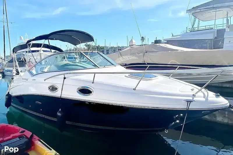 The Image of 2011 Sea Ray 240 Sundancer boat docked in marina under clear blue sky. - 0