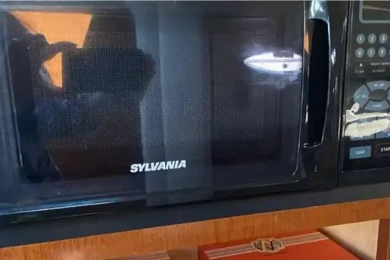 Slide: The Image of Sylvania microwave inside a 2011 Sea Ray 240 Sundancer boat kitchen area. - 10