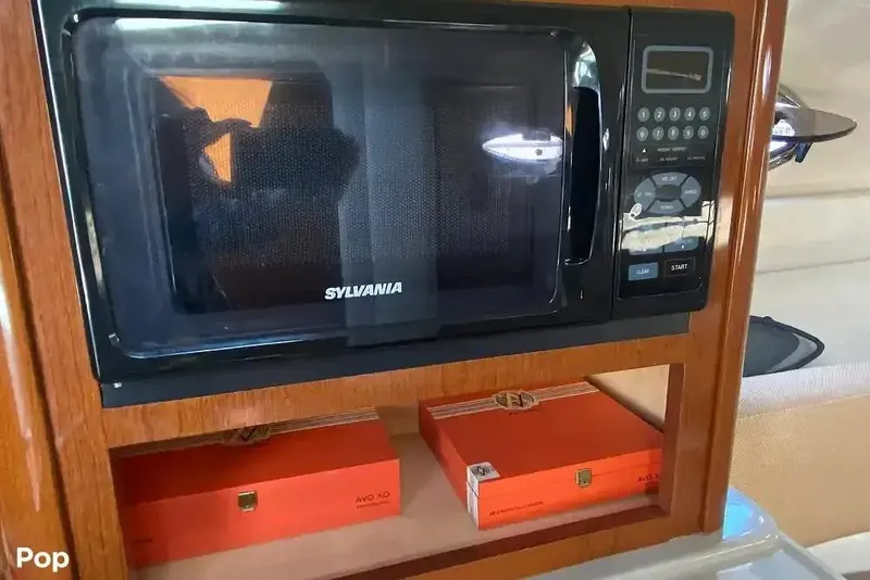 Slide: The Image of Sylvania microwave in 2011 Sea Ray 240 Sundancer boat interior. - 19