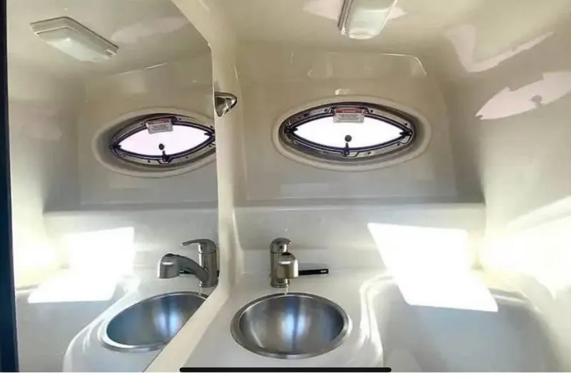 Slide: The Image of Interior of 2011 Sea Ray 240 Sundancer boat with sink and porthole window. - 21