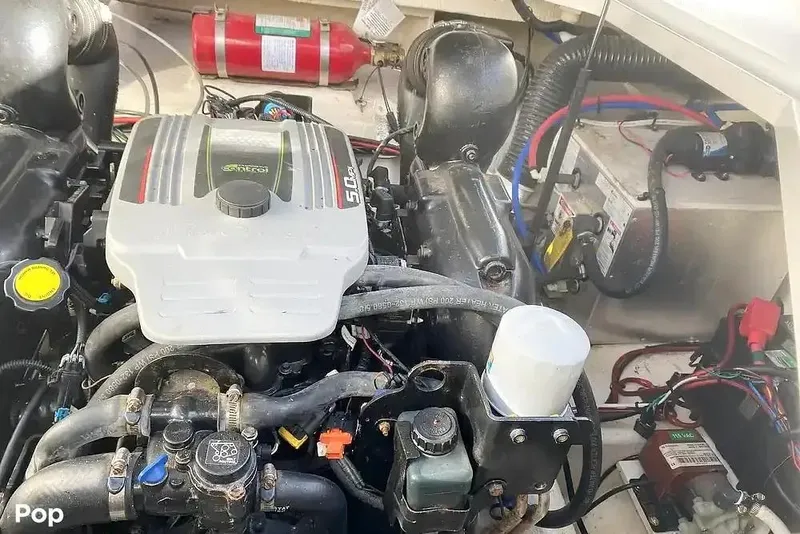 Slide: The Image of Engine compartment of a 2011 Sea Ray 240 Sundancer boat with visible components. - 26